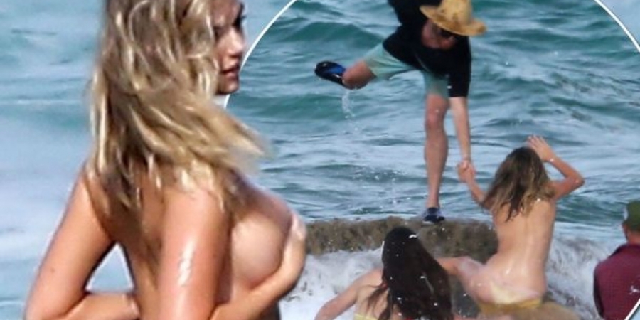 Kate Upton gets swept off a rock during topless photoshoot