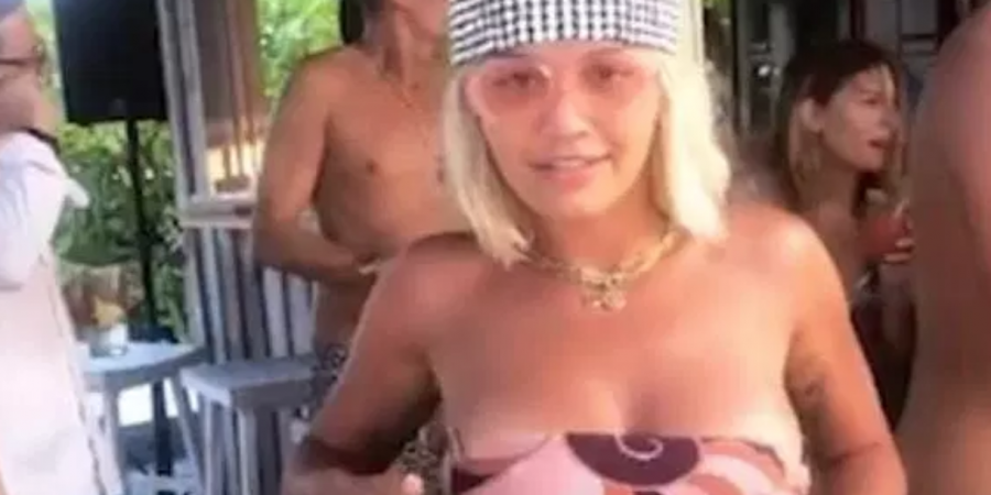 Here's Rita Ora on holiday, getting real boobsy
