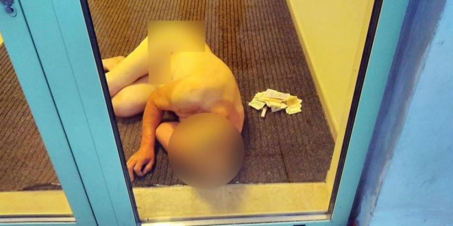 Drunk dude strips naked & falls asleep by ATM machine, thinking it's his bedroom!